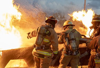 Fire Fighters putting out a burning car