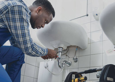 Plumber fixing sink