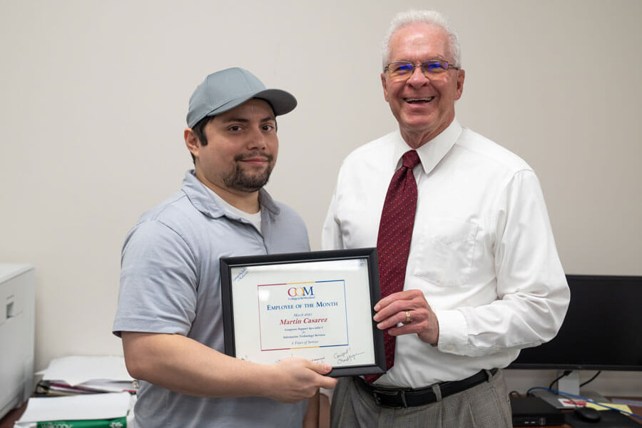 Martin receiving an award from Dr. Nichols
