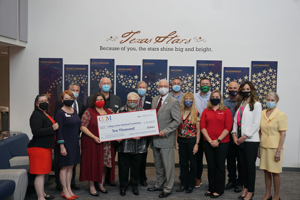 COM receiving a check from the Santa Fe Texas Education Foundation.