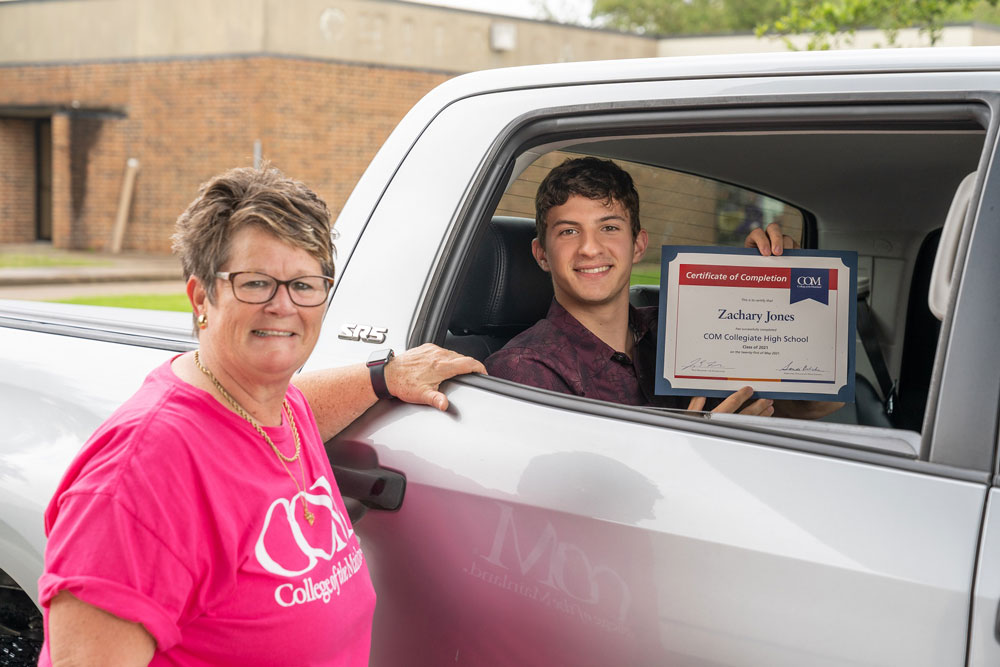 Collegiate High School Director Sandi Belcher and CHS graduate Zachary Jones participate in a car parade held on Friday, May 21.