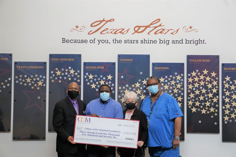 COM Foundation receiving a check from the Dickinson Management District No. 1