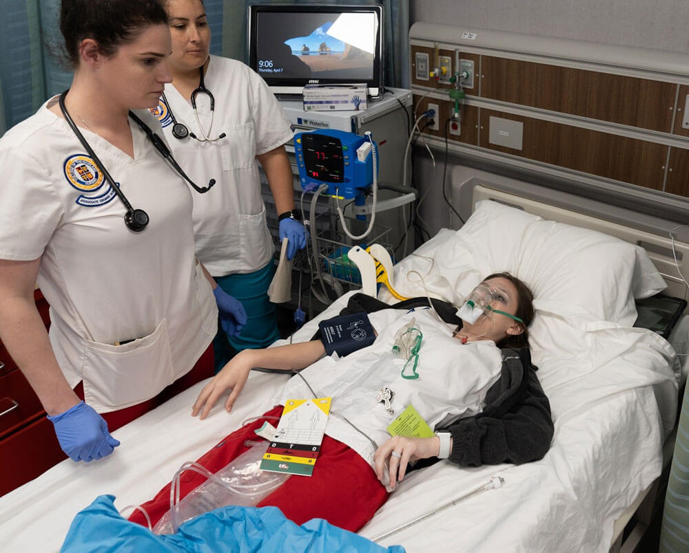 Nursing students participate in a medical emergency simulation