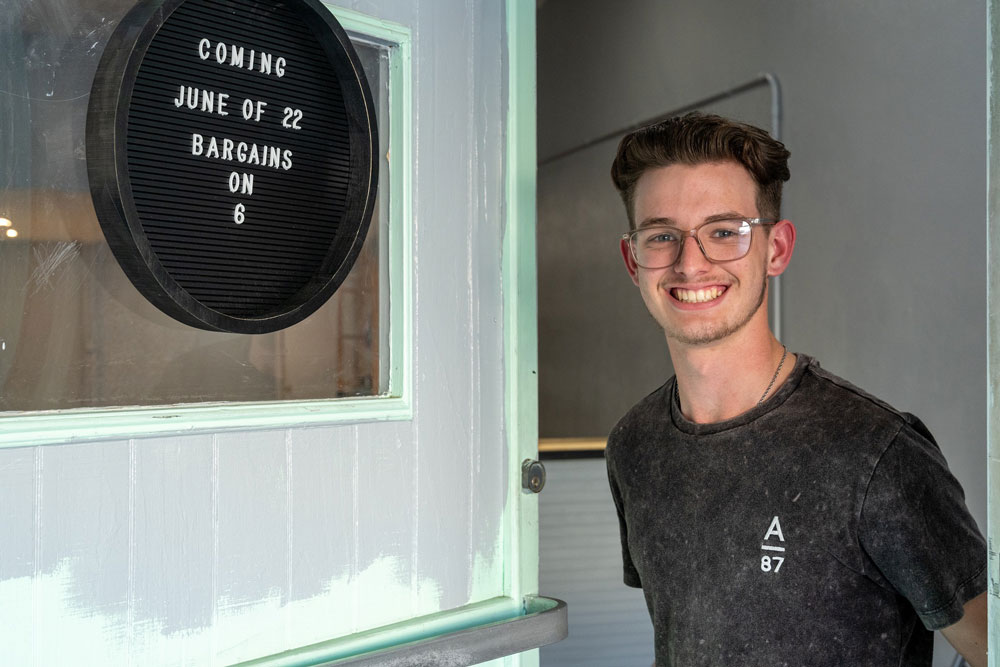 College of the Mainland (COM) Collegiate High School (CHS) student, Austin Kidwell, awaits his Bargains on 6th storefront opening in June 2022.