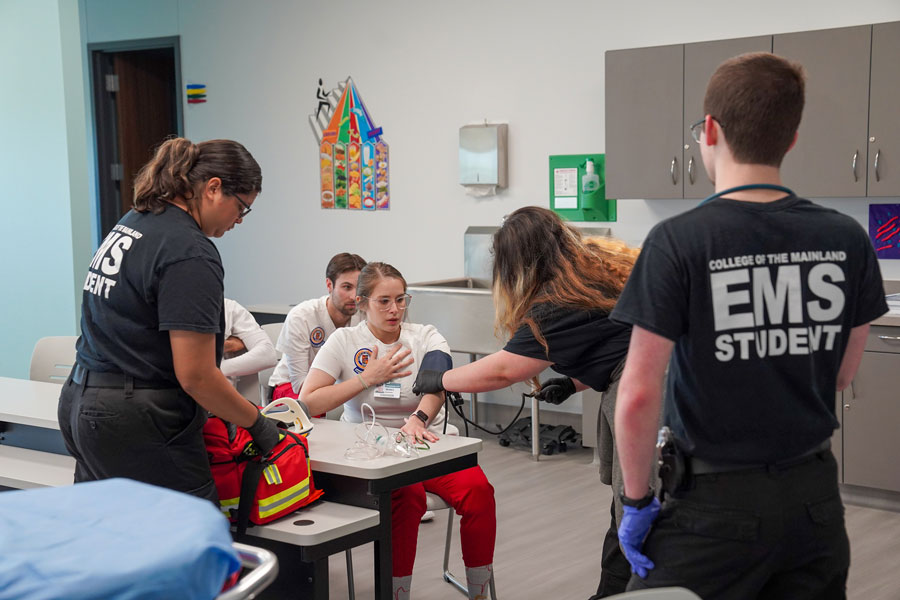 Nursing students participate in a medical emergency simulation.