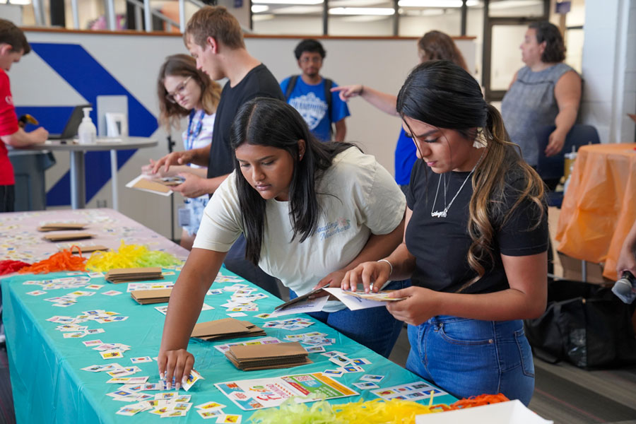 Students select stickers as they create their loteria cards during a Hispanic Heritage Month event.