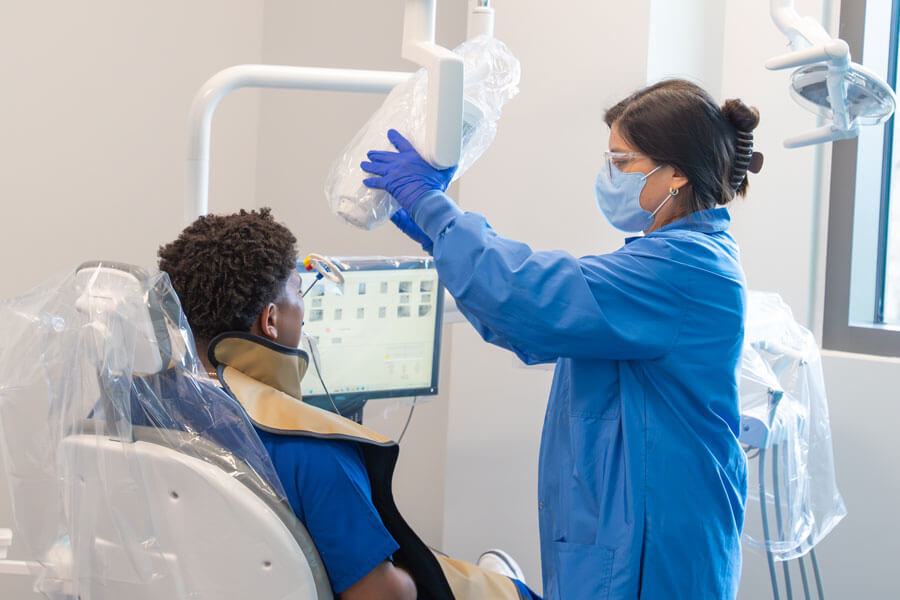 Dental hygiene student performs an x-ray on a patient.