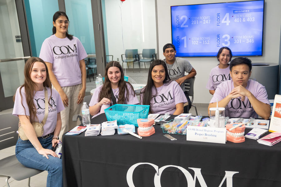 Dental hygiene students at welcome table