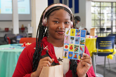 Student holding lotery card