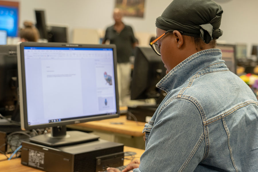 Student using computer to write a paper